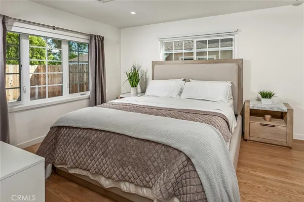 a bed sitting in a bedroom next to a window