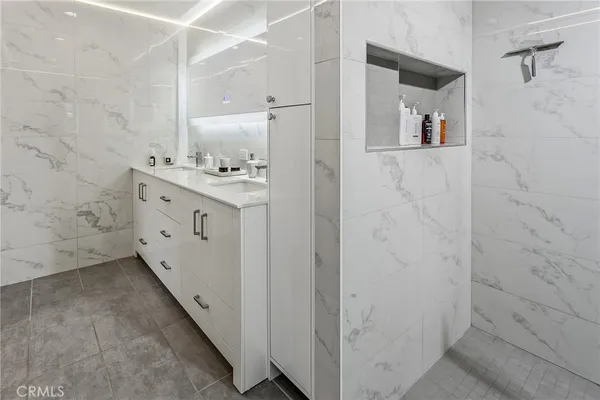 a bathroom with a double vanity sink and mirror