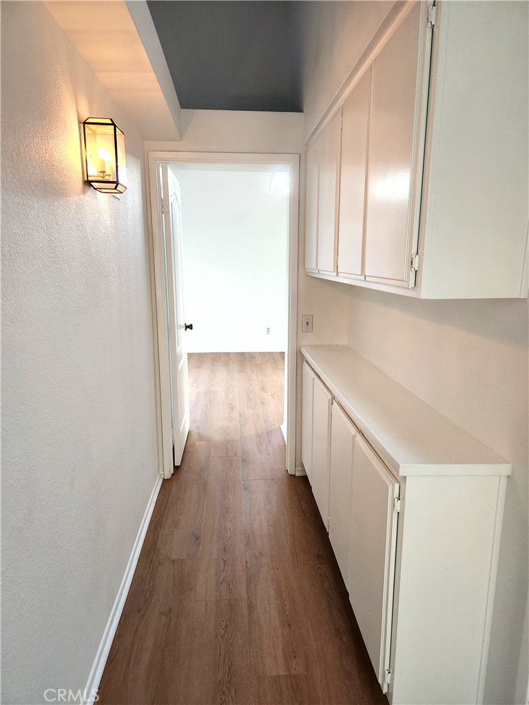 7545 Calais Court Rancho Cucamonga, CA 91730 - Photo 15 of 22 a view of a hallway with wooden floor