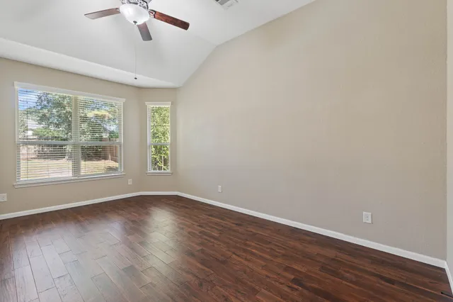 wooden floor in an empty room with a window