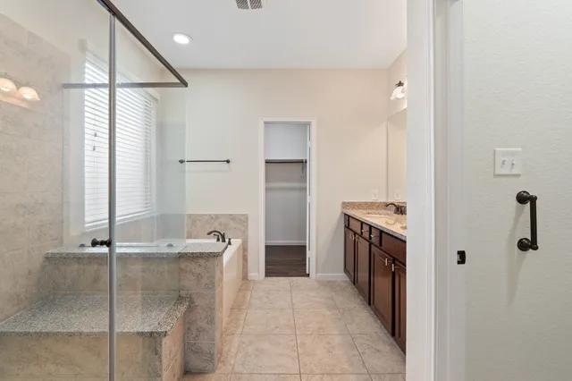 a bathroom with a bathtub and shower
