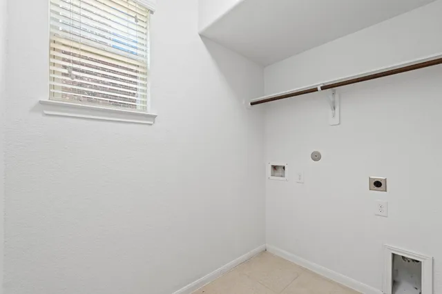 a view of staircase with railing and a window