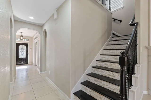 an empty room with windows and fireplace