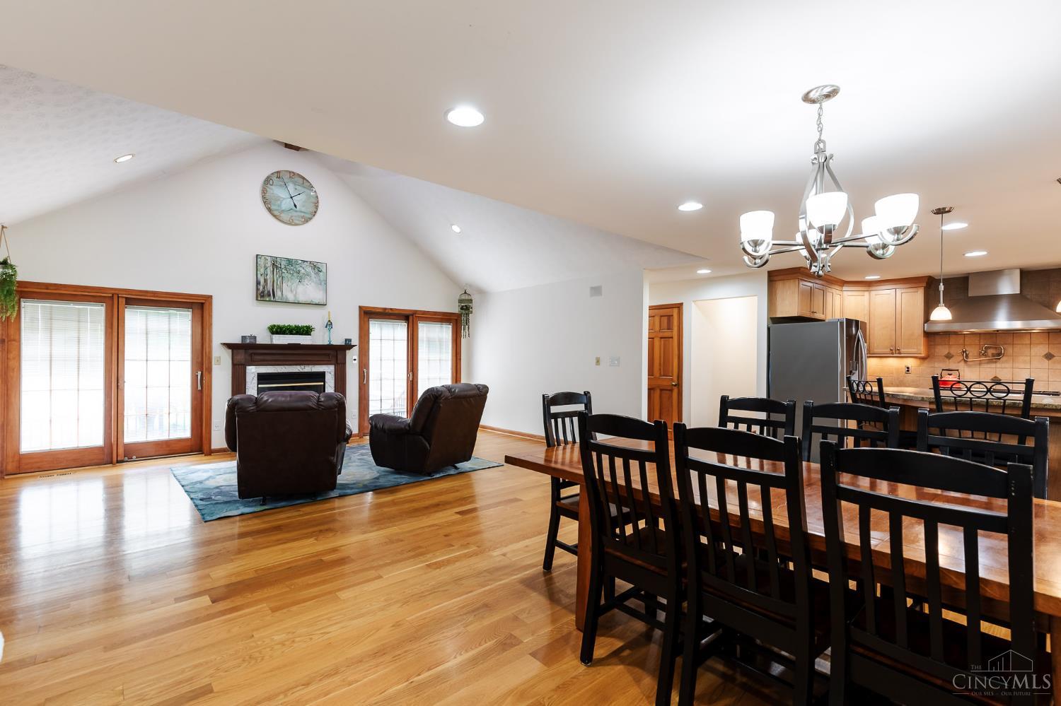 623 Ibold Road Loveland, OH 45140 - Photo 4 of 35 Step inside to an inviting open-concept design featuring vaulted ceilings, hardwood floors and seamless flow between the living, dining and kitchen areas.