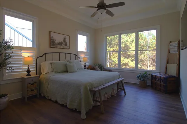 a bedroom with a bed and painting on the wall