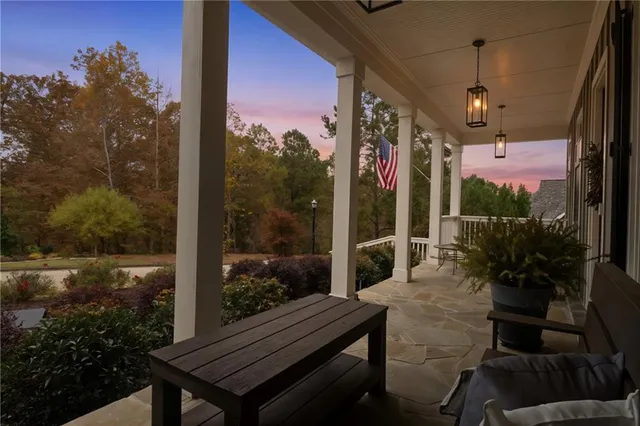 a view of a balcony with chairs and a potted plant