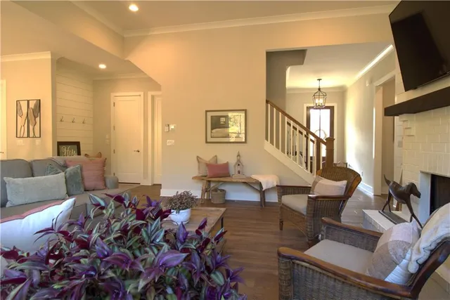 a living room with furniture a fireplace and a flat screen tv