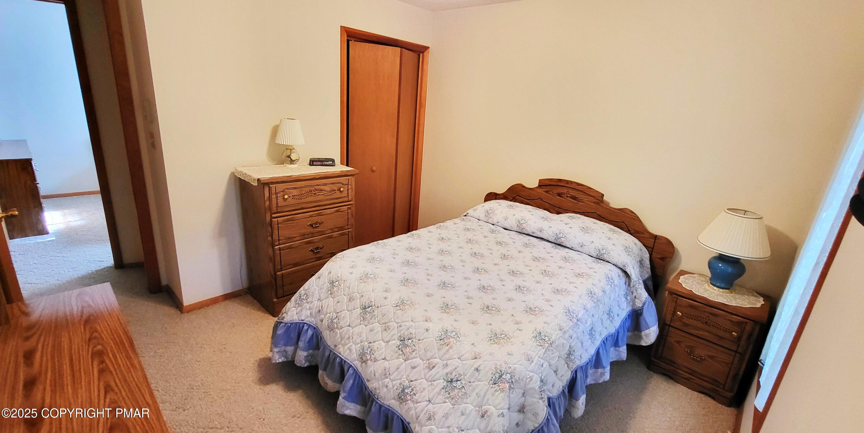 188 Radcliff Road Bushkill, PA 18324 - Photo 24 of 51 a bedroom with a bed and a flat tv screen next to a window