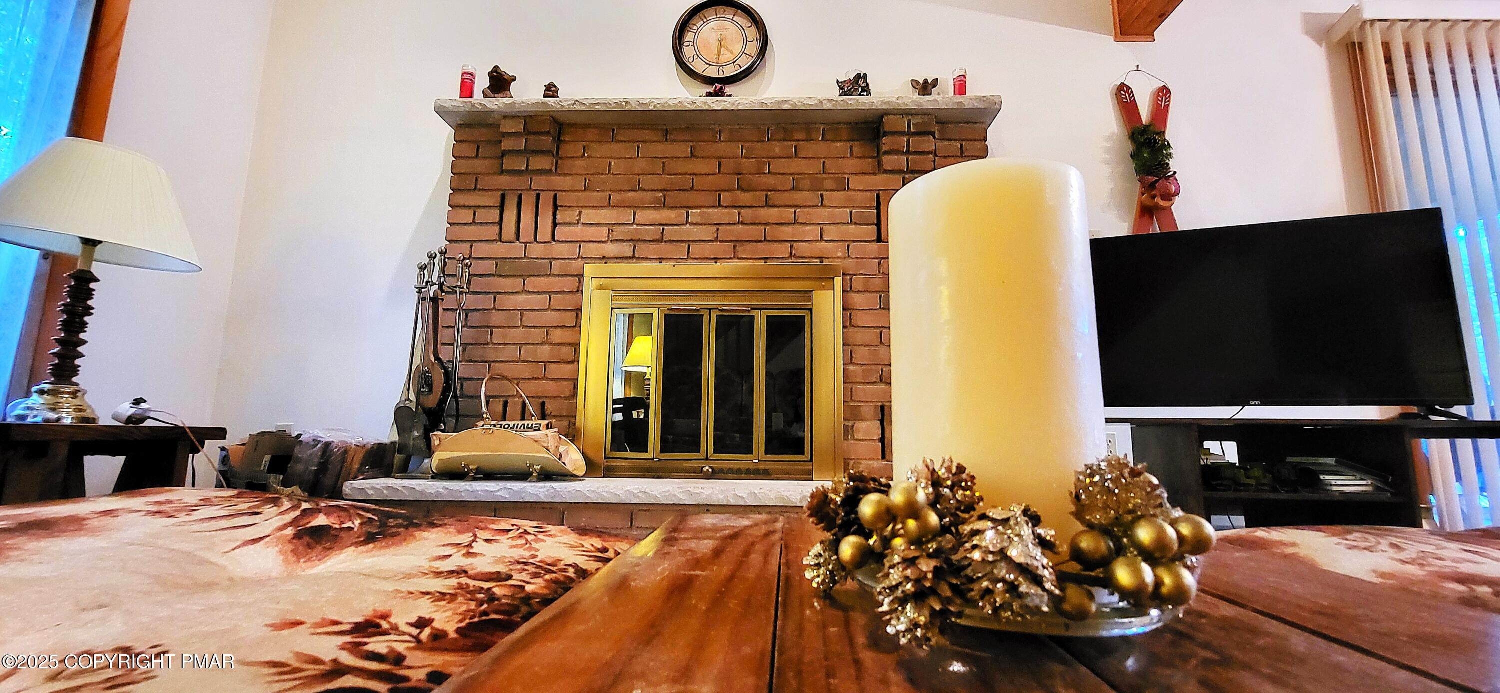 188 Radcliff Road Bushkill, PA 18324 - Photo 3 of 51 a living room with fireplace furniture and a flat screen tv