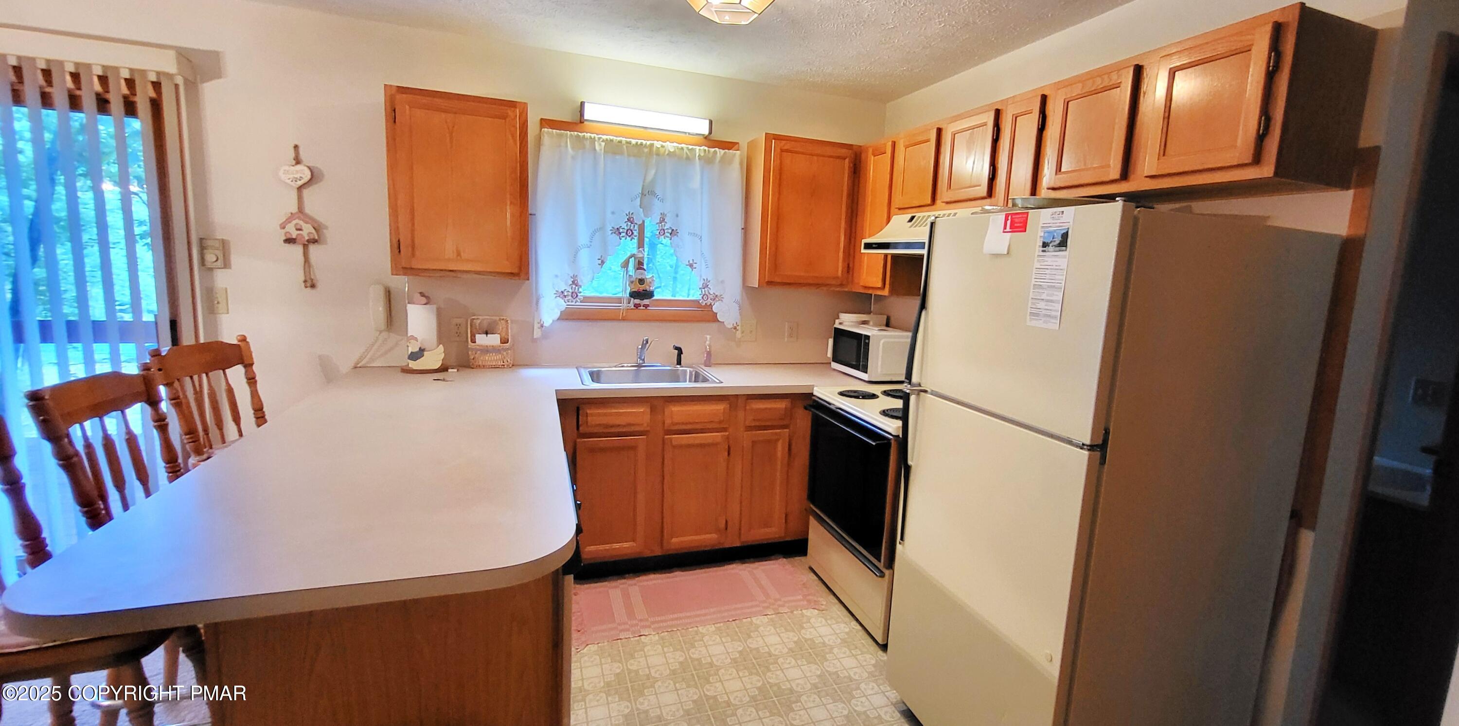 188 Radcliff Road Bushkill, PA 18324 - Photo 8 of 51 a kitchen with refrigerator a stove a sink dishwasher and a refrigerator