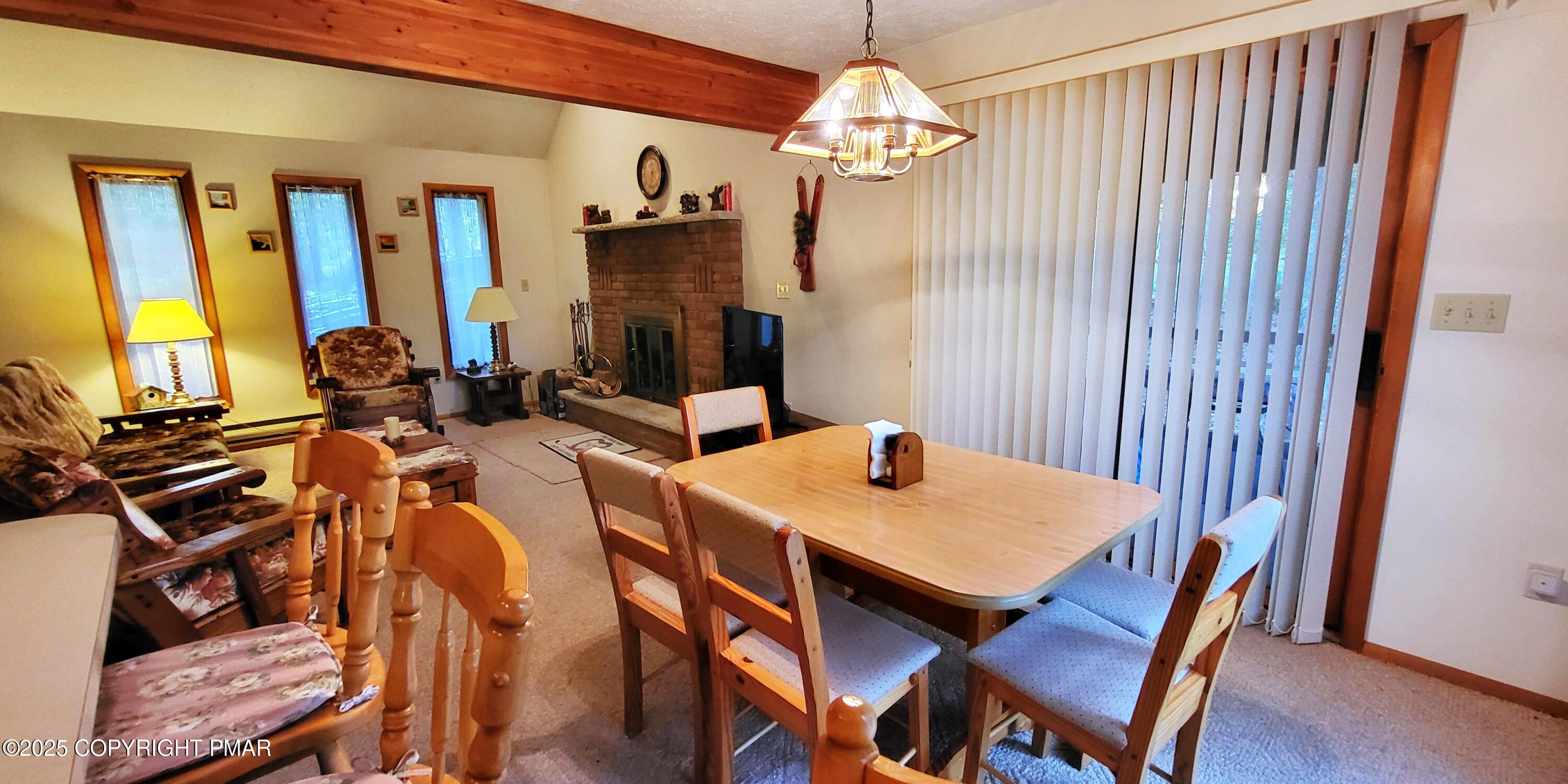 188 Radcliff Road Bushkill, PA 18324 - Photo 9 of 51 a view of a dining room with furniture a chandelier and wooden floor