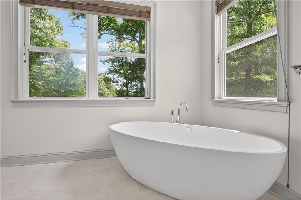 632 Geiger Road Jefferson, GA 30549 - Photo 30 of 55 a white bath tub sitting in a bathroom next to a window