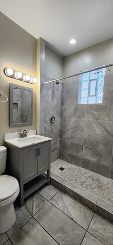 a bathroom with a sink mirror and shower