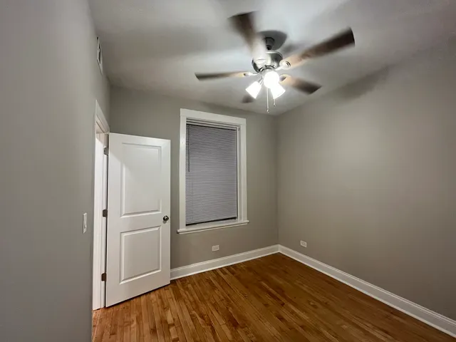 a view of a room with wooden floor and windows