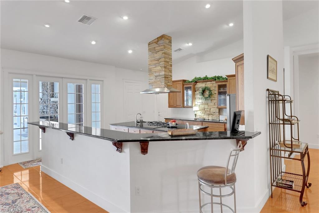 2825 Jenkins Way Naples, FL 34117 - Photo 11 of 50 a kitchen with kitchen island granite countertop a sink and cabinets