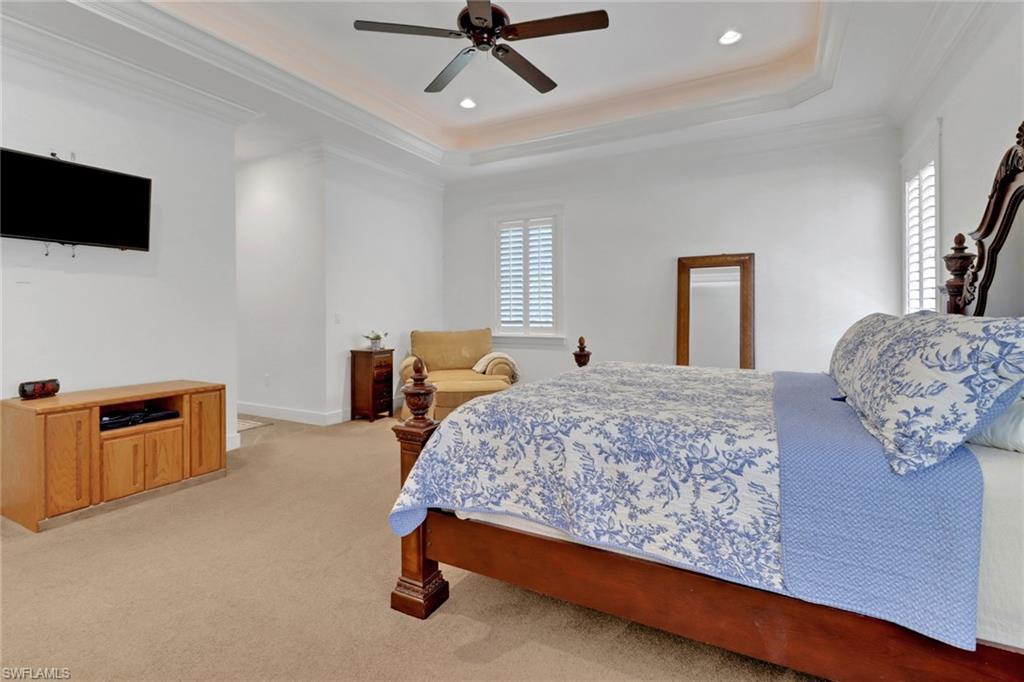 2825 Jenkins Way Naples, FL 34117 - Photo 28 of 50 a bedroom with a bed and flat screen tv