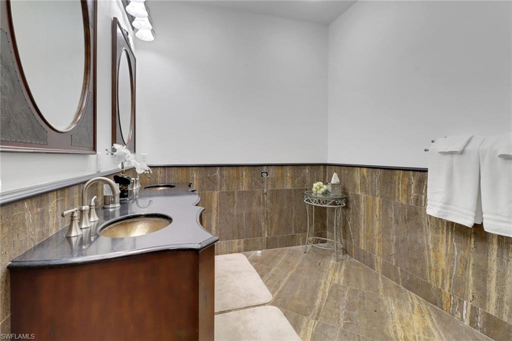 2825 Jenkins Way Naples, FL 34117 - Photo 29 of 50 a bathroom with a sink and a mirror