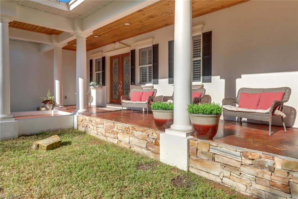 2825 Jenkins Way Naples, FL 34117 - Photo 3 of 50 a building outdoor space with patio furniture and potted plants