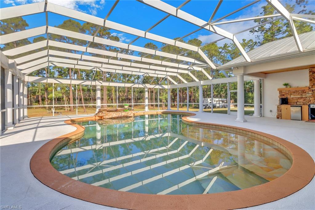 2825 Jenkins Way Naples, FL 34117 - Photo 35 of 50 a view of a swimming pool with a patio