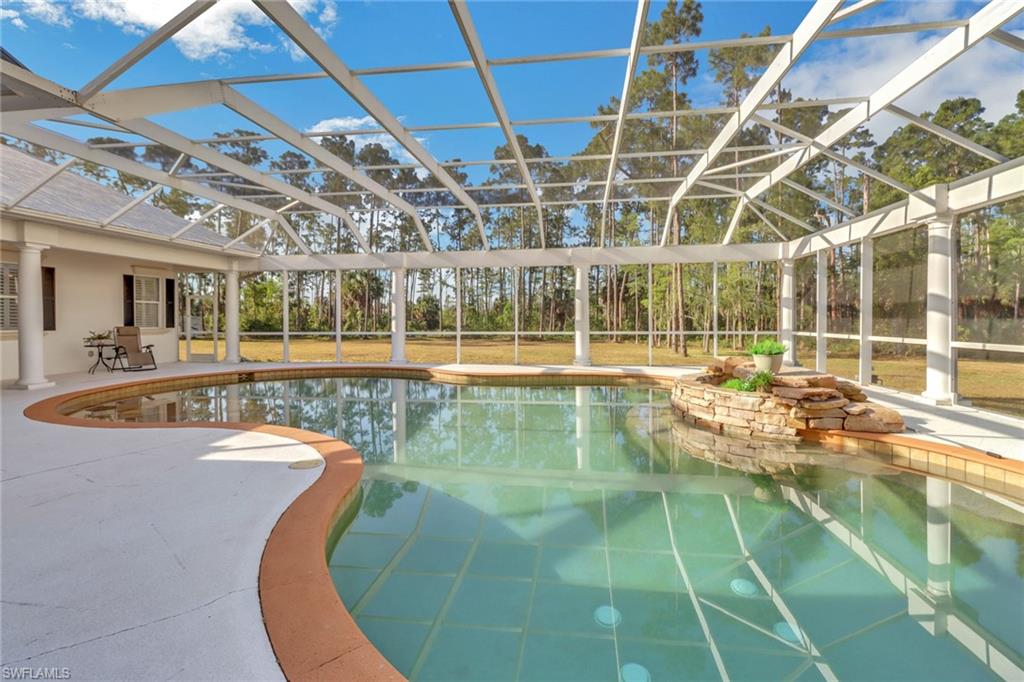 2825 Jenkins Way Naples, FL 34117 - Photo 36 of 50 a view of a swimming pool with a patio