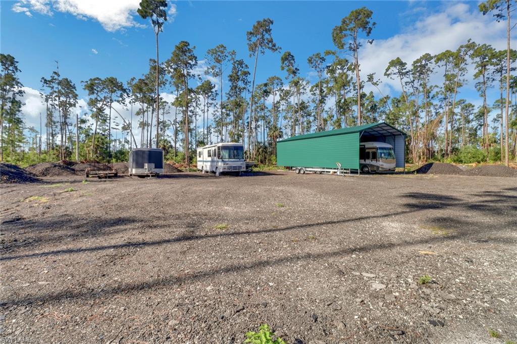 2825 Jenkins Way Naples, FL 34117 - Photo 39 of 50 a view of a house with a yard and a car parked in front of it