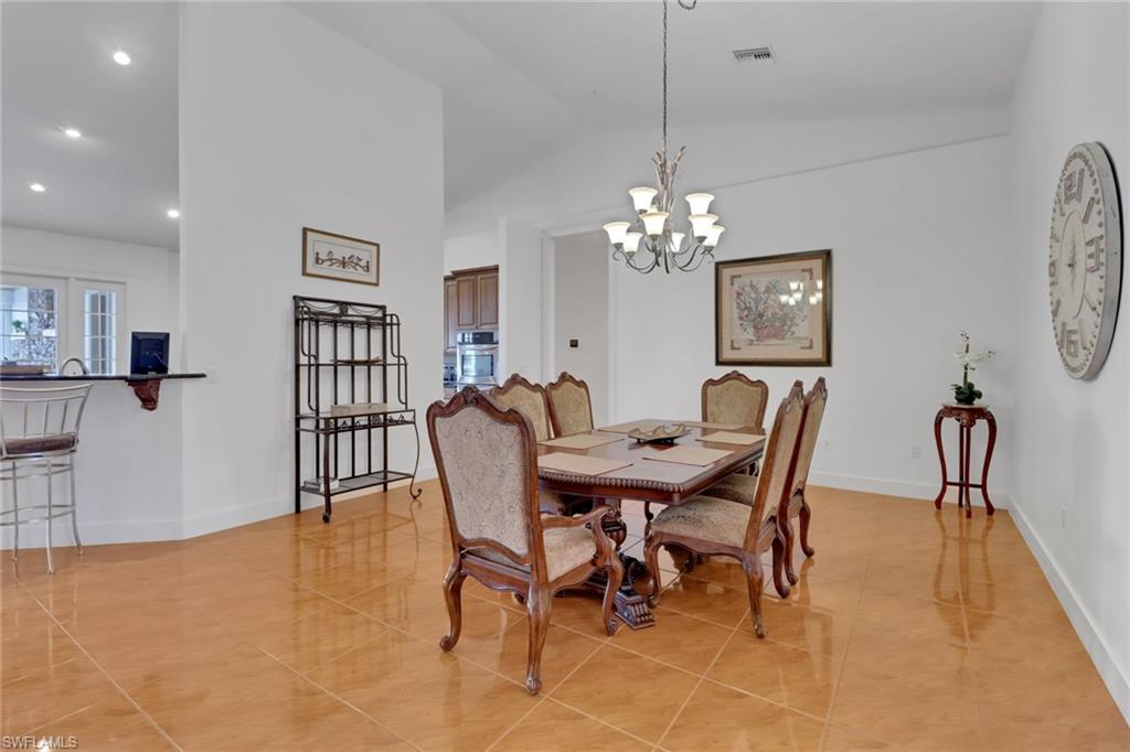 2825 Jenkins Way Naples, FL 34117 - Photo 6 of 50 a view of a dining room with furniture and chandelier