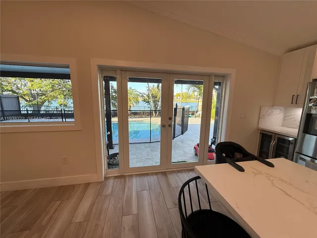 a living room with furniture a flat screen tv and a window
