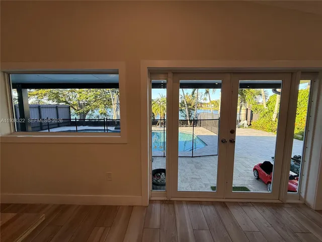 a living room with furniture a flat screen tv and a window
