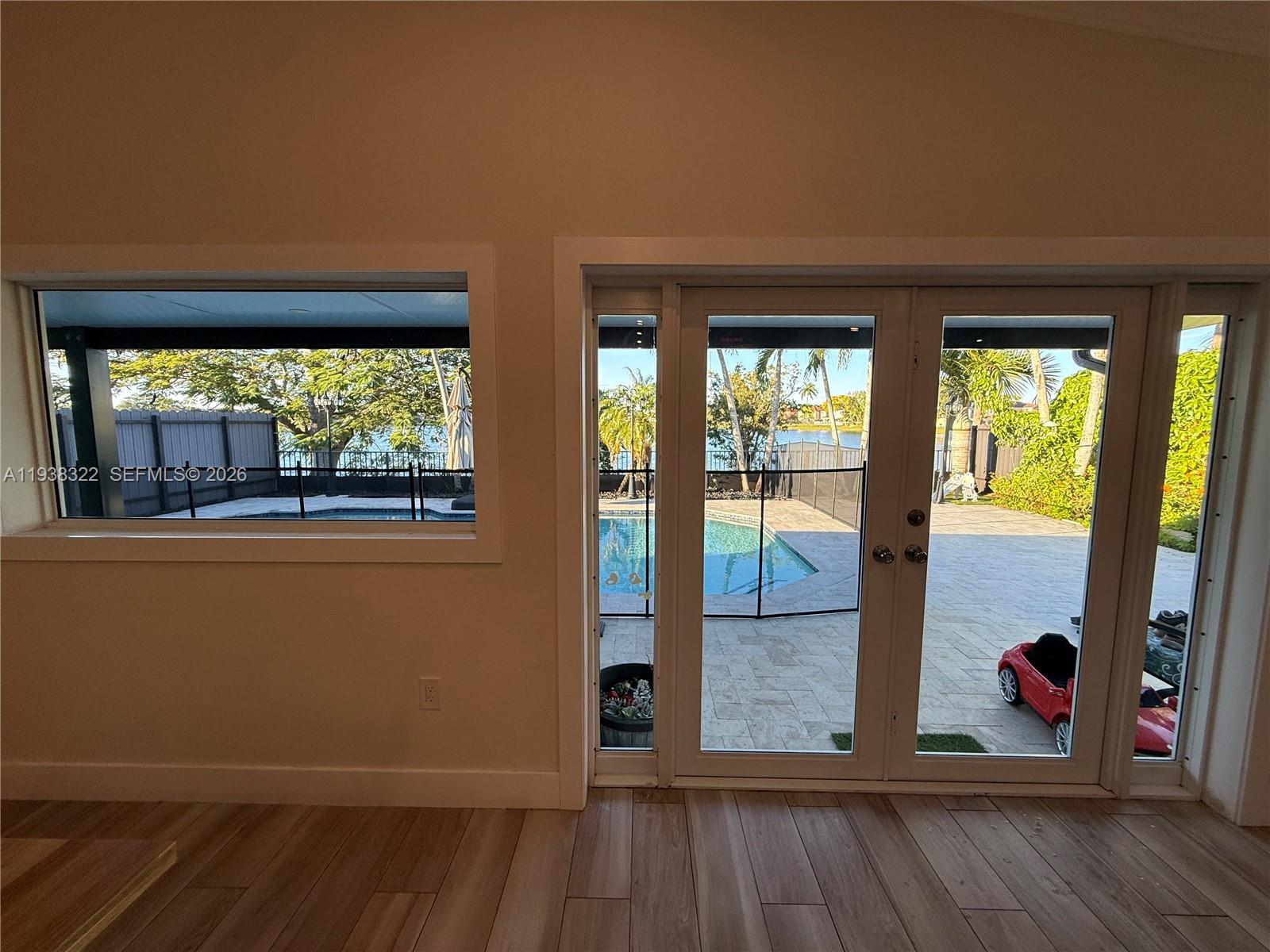 8335 Northwest 197th Terrace Hialeah, FL 33015 - Photo 13 of 51 an empty room with wooden floor and windows
