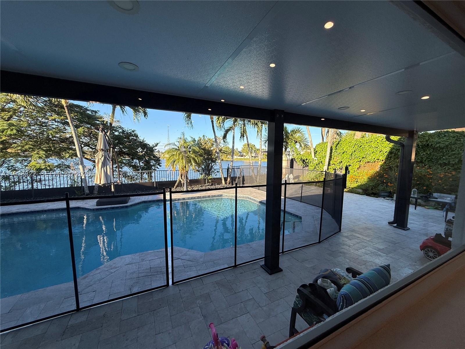 8335 Northwest 197th Terrace Hialeah, FL 33015 - Photo 16 of 51 a living room with large windows and furniture