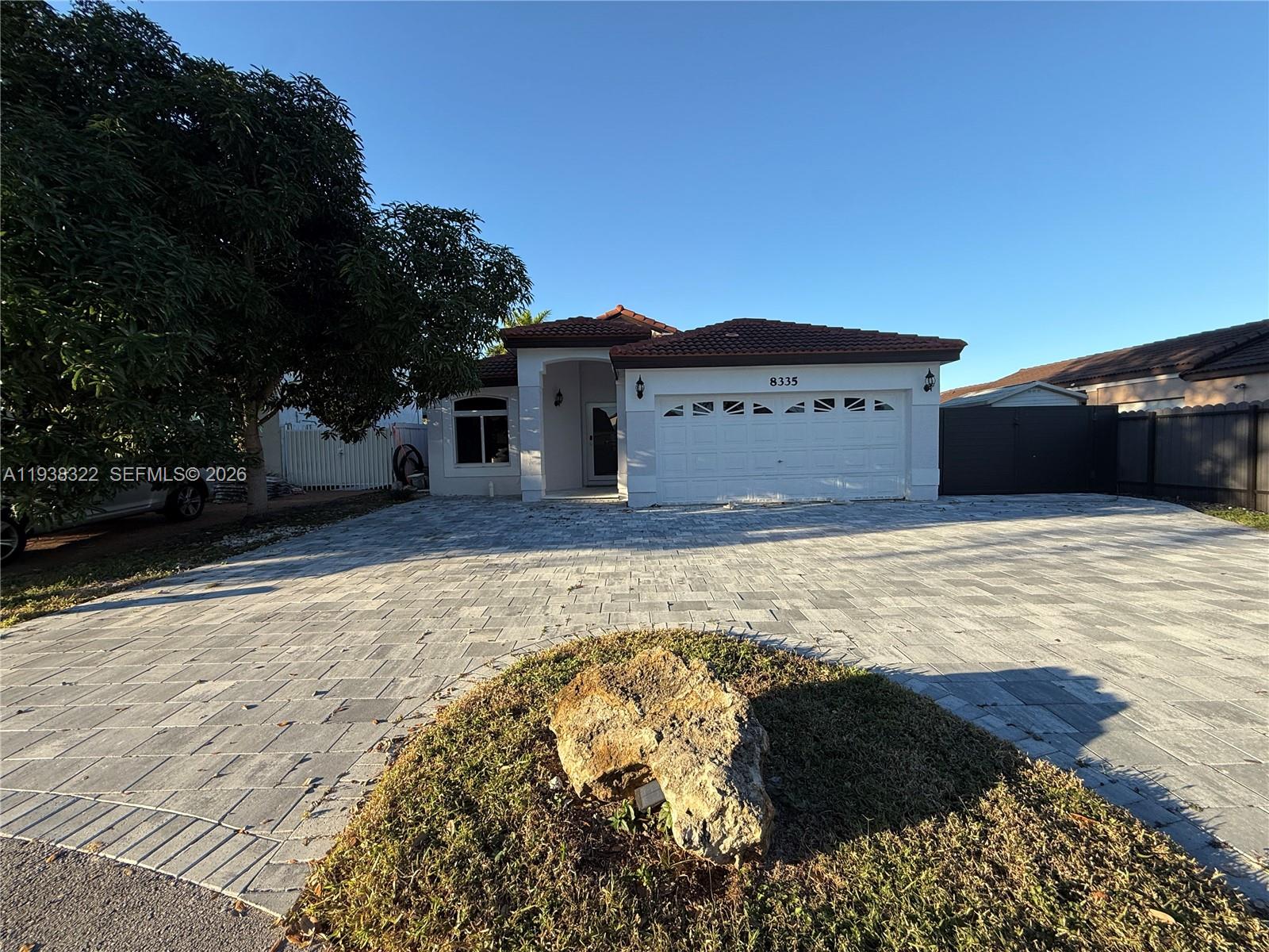 8335 Northwest 197th Terrace Hialeah, FL 33015 - Photo 2 of 51 a view of a house with a yard