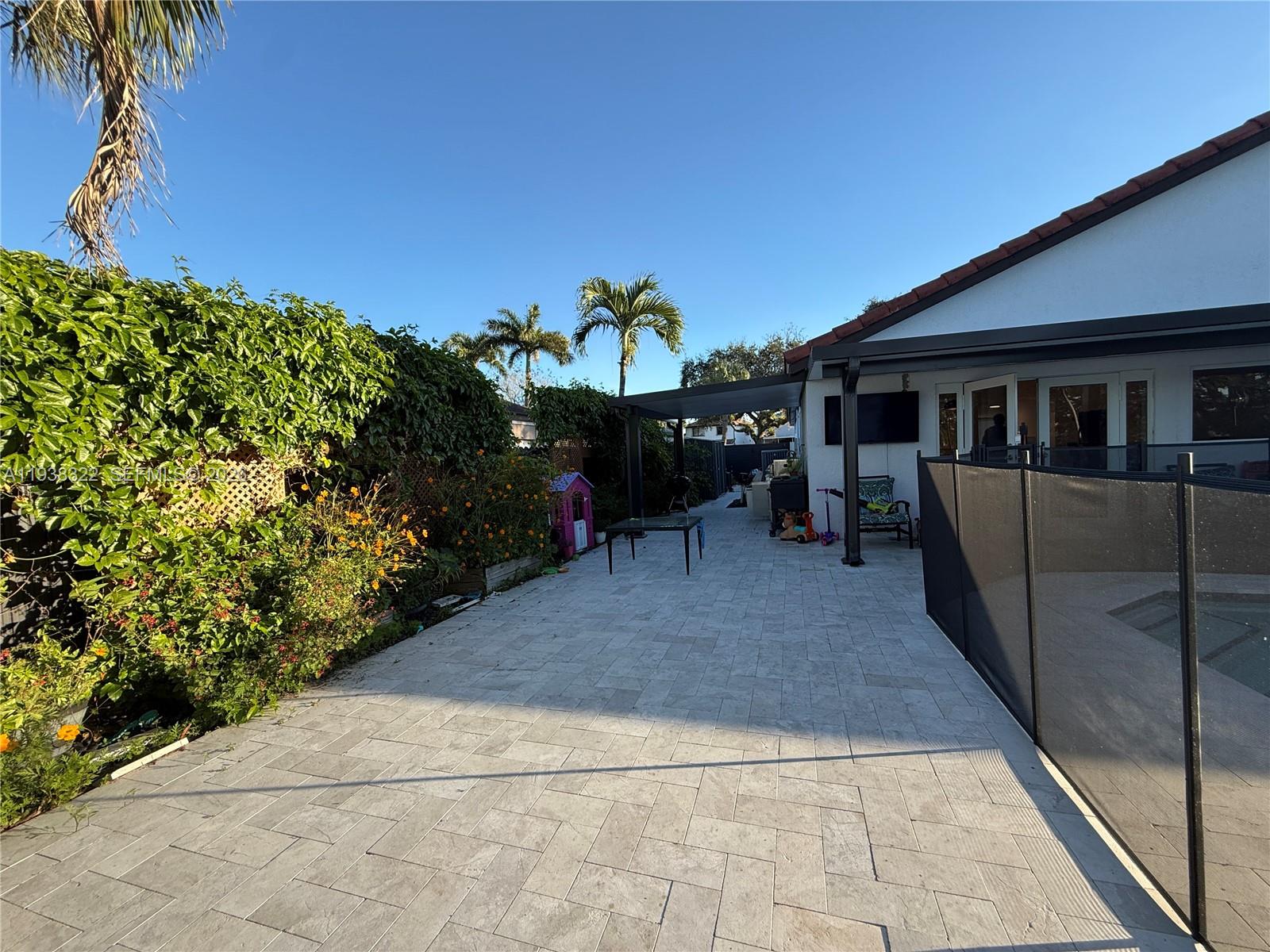 8335 Northwest 197th Terrace Hialeah, FL 33015 - Photo 22 of 51 a view of a porch with chairs and potted plants