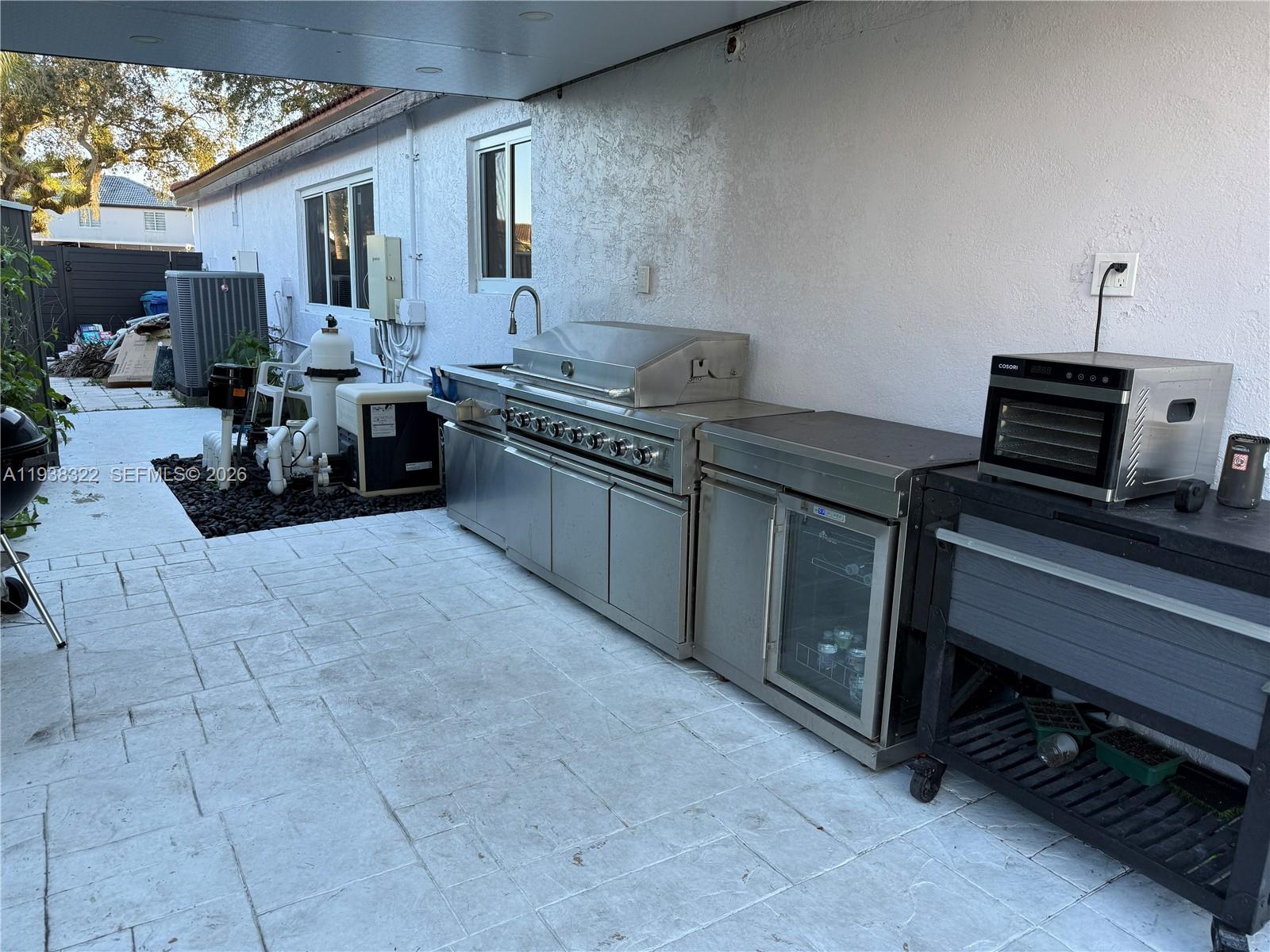 8335 Northwest 197th Terrace Hialeah, FL 33015 - Photo 25 of 51 a kitchen with stainless steel appliances a sink stove and cabinets