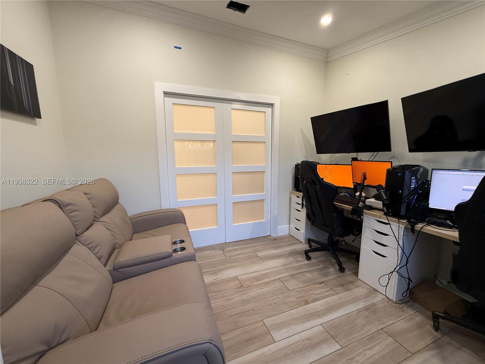 8335 Northwest 197th Terrace Hialeah, FL 33015 - Photo 30 of 51 a living room with furniture a flat screen tv and a window