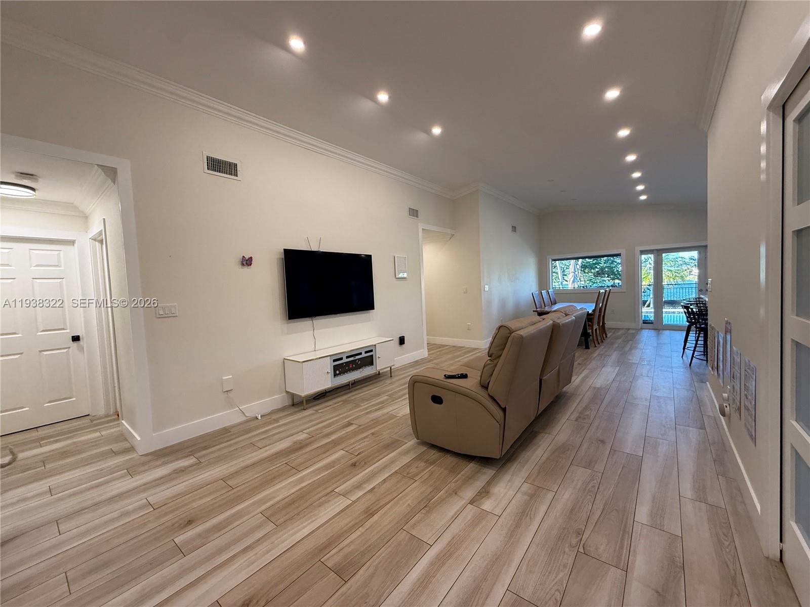 8335 Northwest 197th Terrace Hialeah, FL 33015 - Photo 3 of 51 a living room with furniture and a flat screen tv