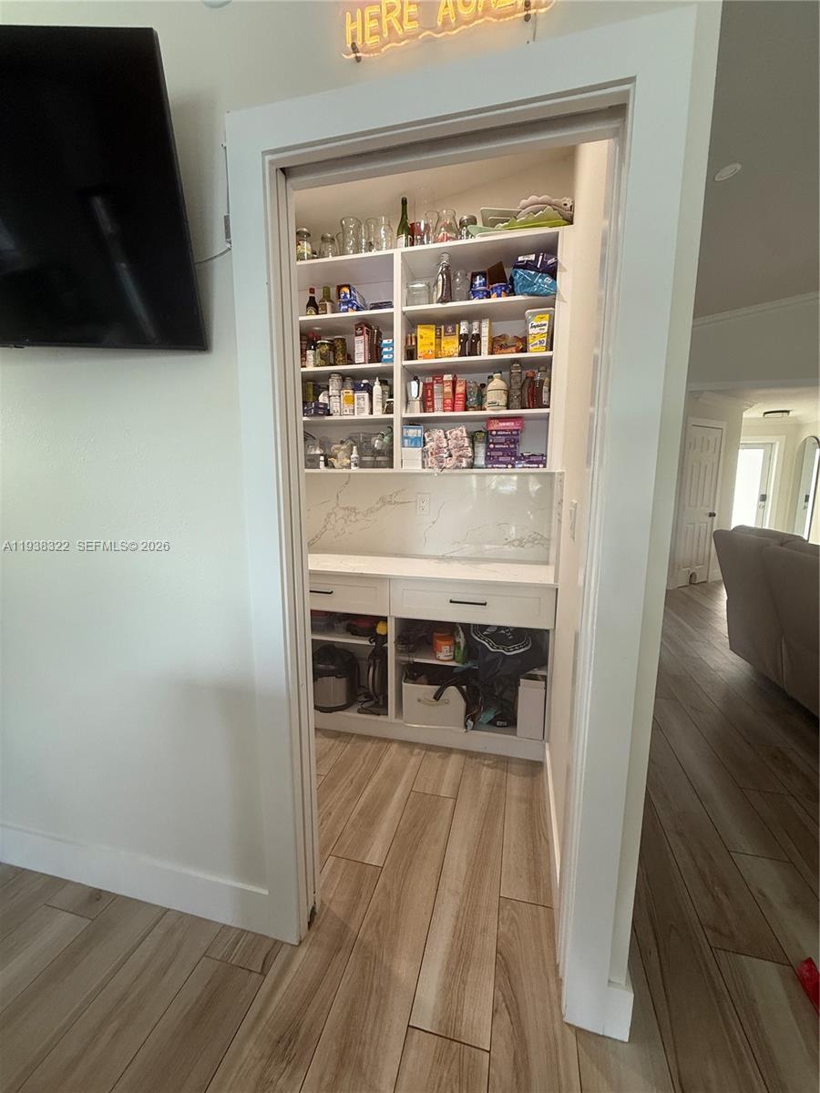 8335 Northwest 197th Terrace Hialeah, FL 33015 - Photo 32 of 51 a room with wooden floor and furniture