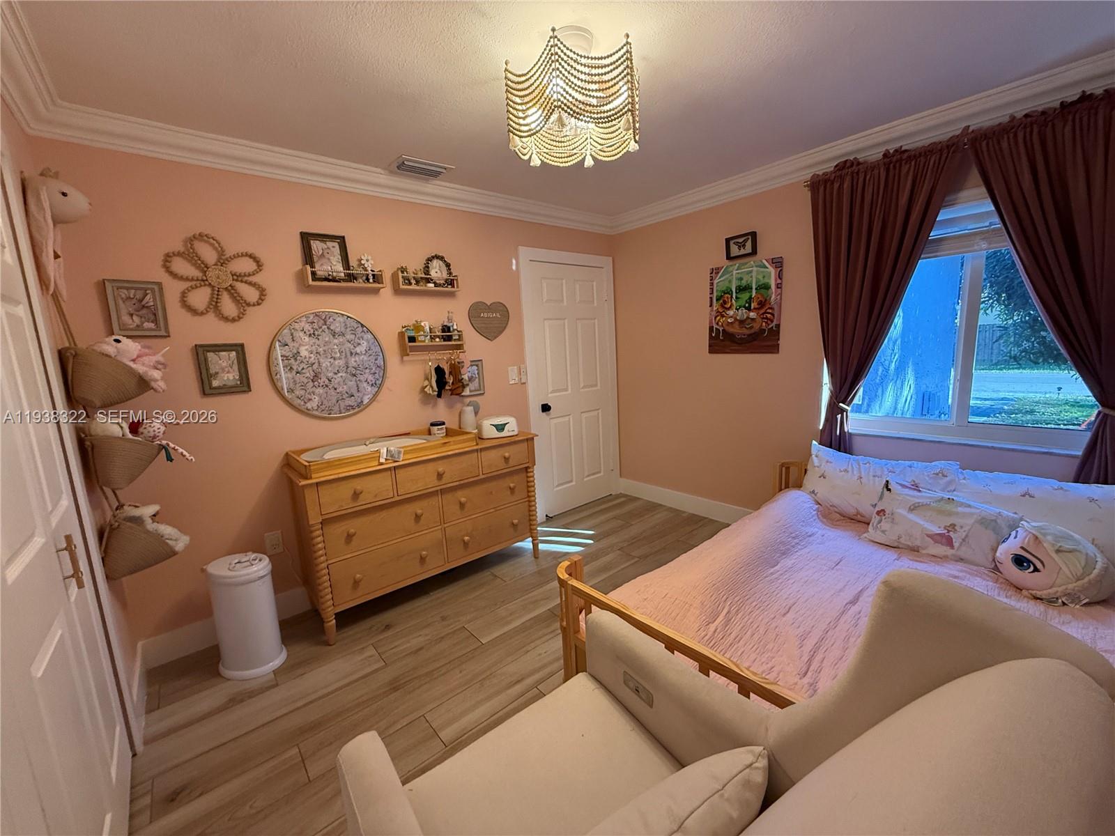 8335 Northwest 197th Terrace Hialeah, FL 33015 - Photo 36 of 51 a bedroom with a bed and wooden floor