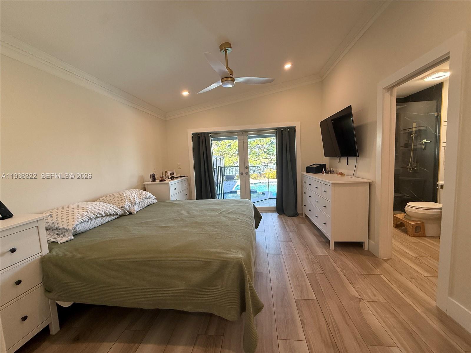 8335 Northwest 197th Terrace Hialeah, FL 33015 - Photo 43 of 51 a bedroom with a bed and a flat screen tv