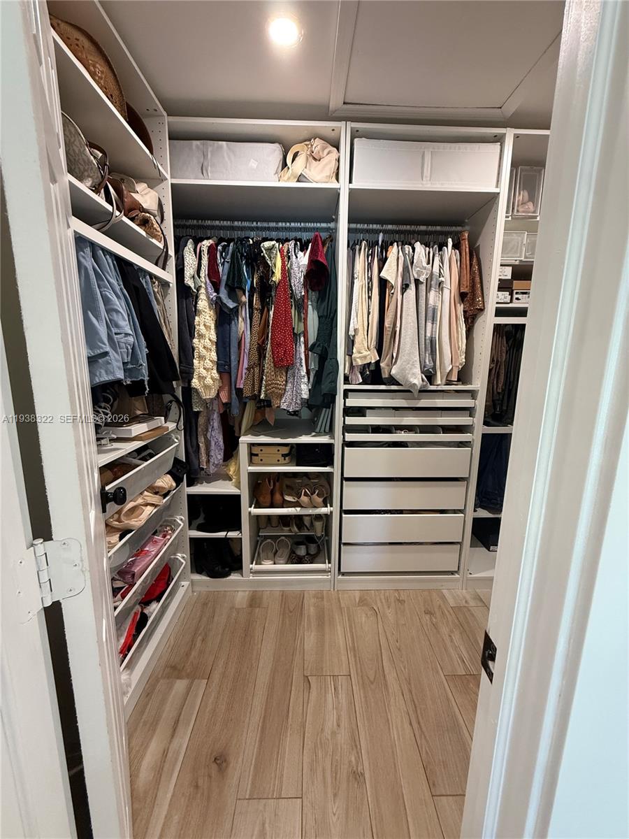 8335 Northwest 197th Terrace Hialeah, FL 33015 - Photo 44 of 51 a view of walk in closet with clothes and shoes