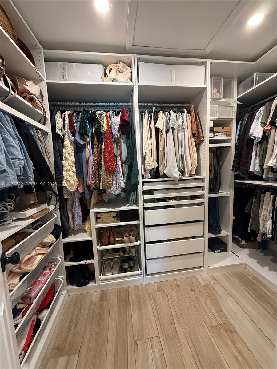 8335 Northwest 197th Terrace Hialeah, FL 33015 - Photo 45 of 51 a view of walk in closet with clothes and shoes
