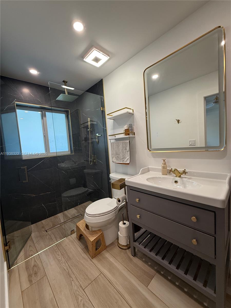 8335 Northwest 197th Terrace Hialeah, FL 33015 - Photo 46 of 51 a bathroom with a toilet sink mirror and vanity