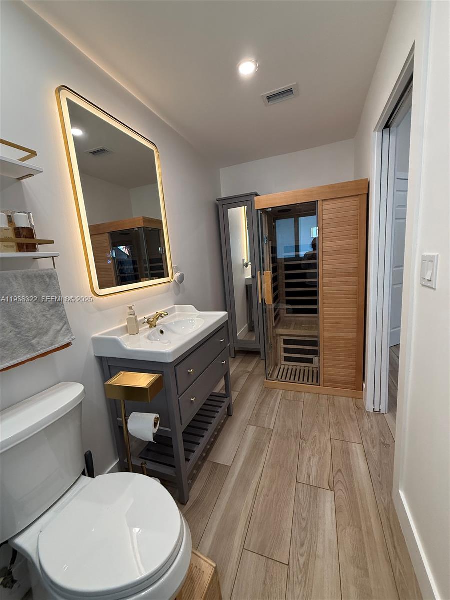 8335 Northwest 197th Terrace Hialeah, FL 33015 - Photo 47 of 51 a bathroom with a toilet a sink and a mirror