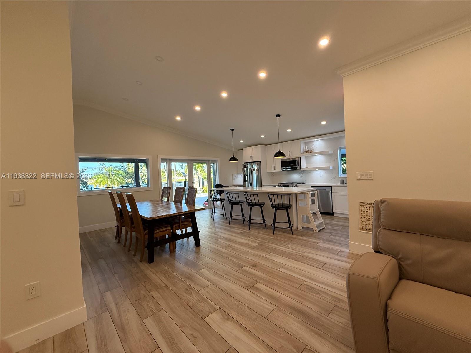 8335 Northwest 197th Terrace Hialeah, FL 33015 - Photo 5 of 51 a living room with couches and kitchen view with wooden floor