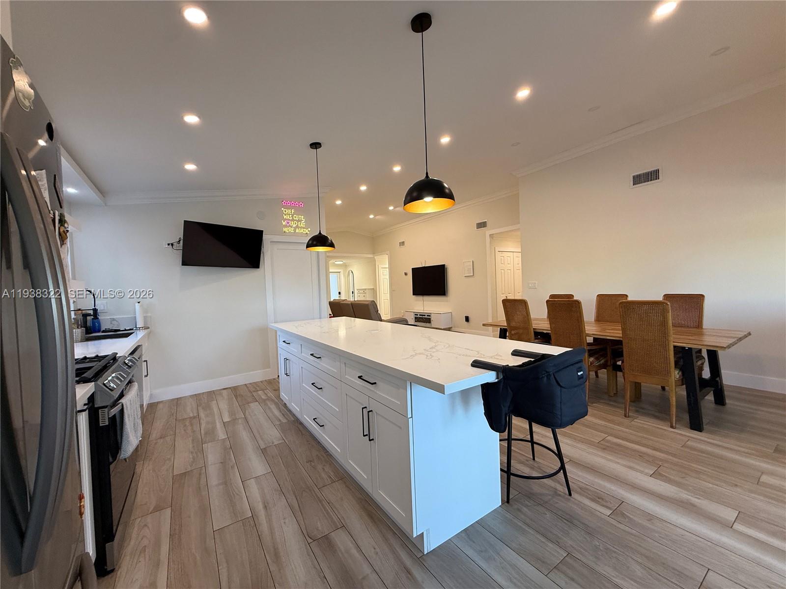 8335 Northwest 197th Terrace Hialeah, FL 33015 - Photo 9 of 51 a large kitchen with stainless steel appliances granite countertop a stove and a wooden floors