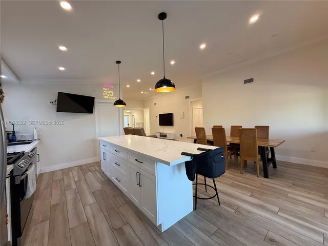 a view of a porch with chairs and potted plants