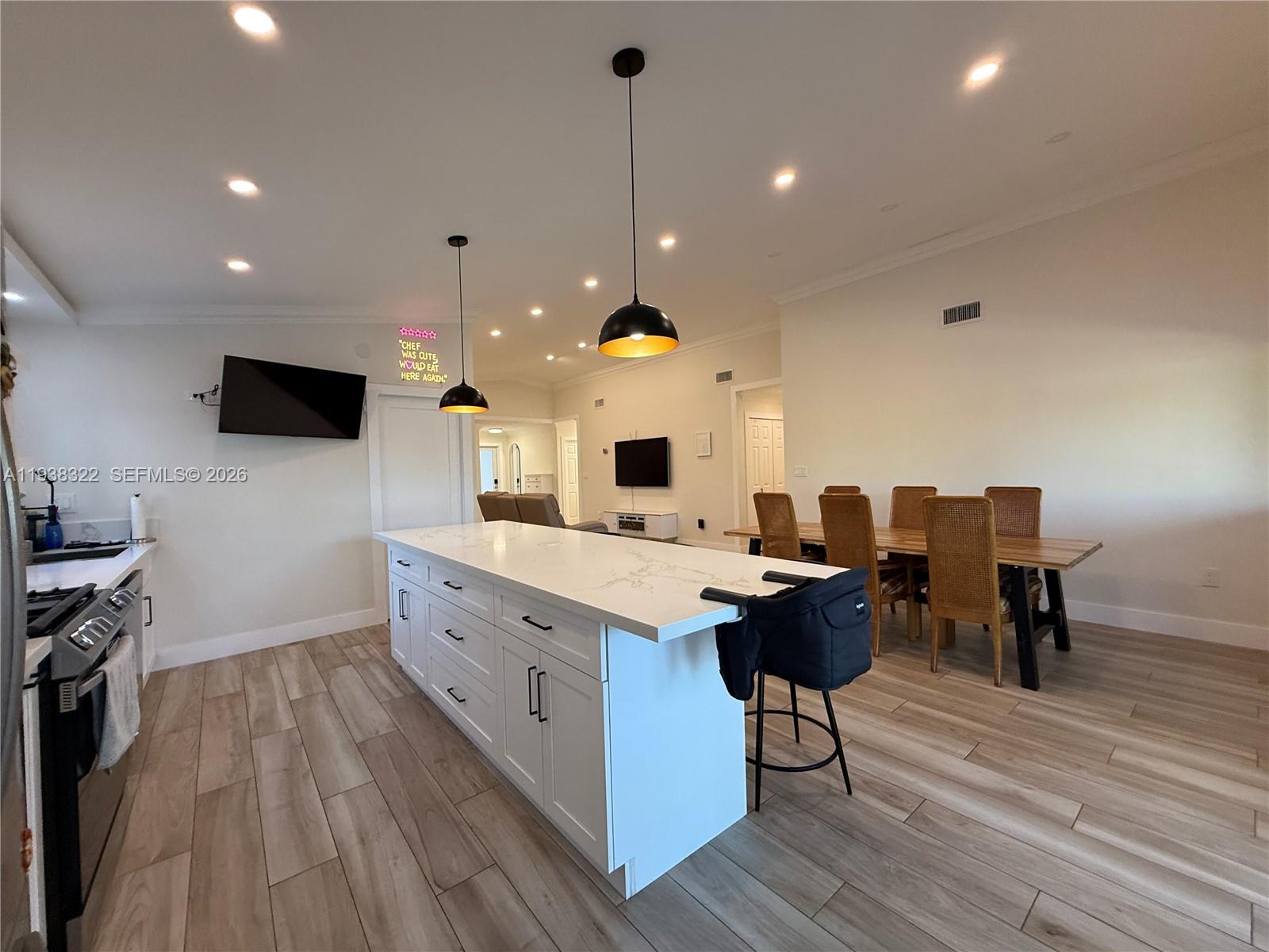 8335 Northwest 197th Terrace Hialeah, FL 33015 - Photo 10 of 51 a large kitchen with kitchen island a counter space a sink stainless steel appliances and cabinets