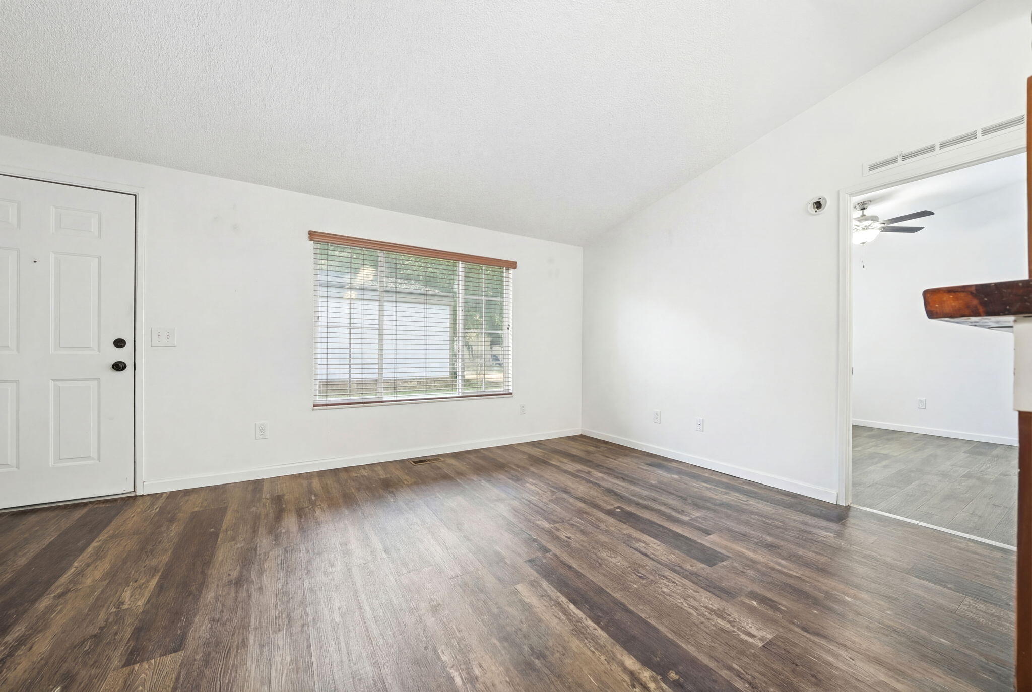11705 Parey Avenue, Unit 7 Red Bluff, CA 96080 - Photo 13 of 34 an empty room with wooden floor and windows