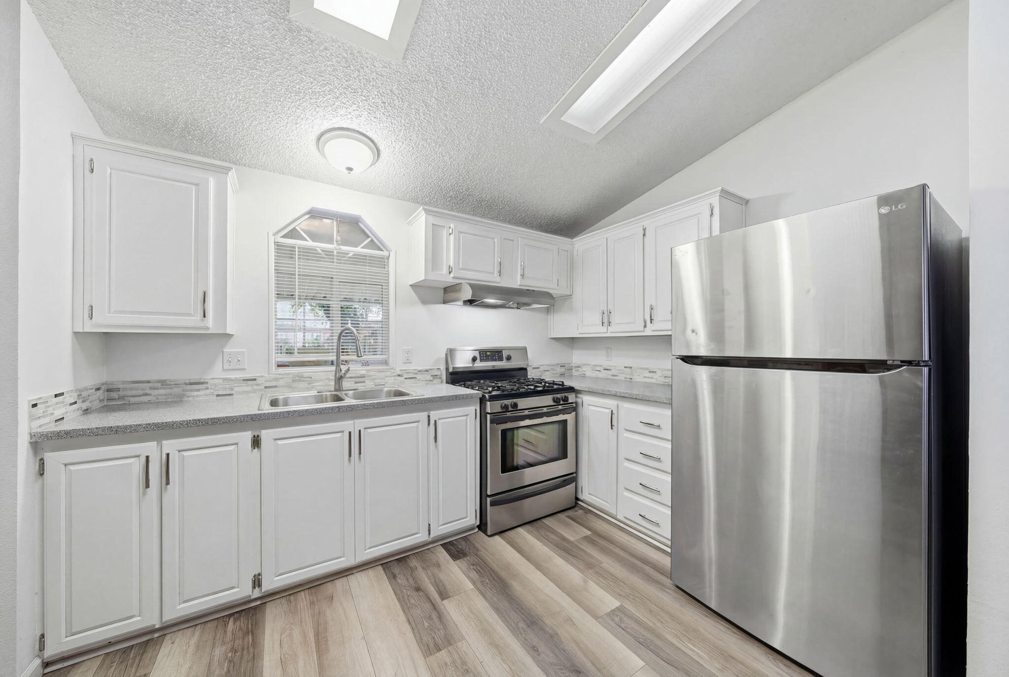11705 Parey Avenue, Unit 7 Red Bluff, CA 96080 - Photo 14 of 34 a kitchen with stainless steel appliances granite countertop a refrigerator sink and stove