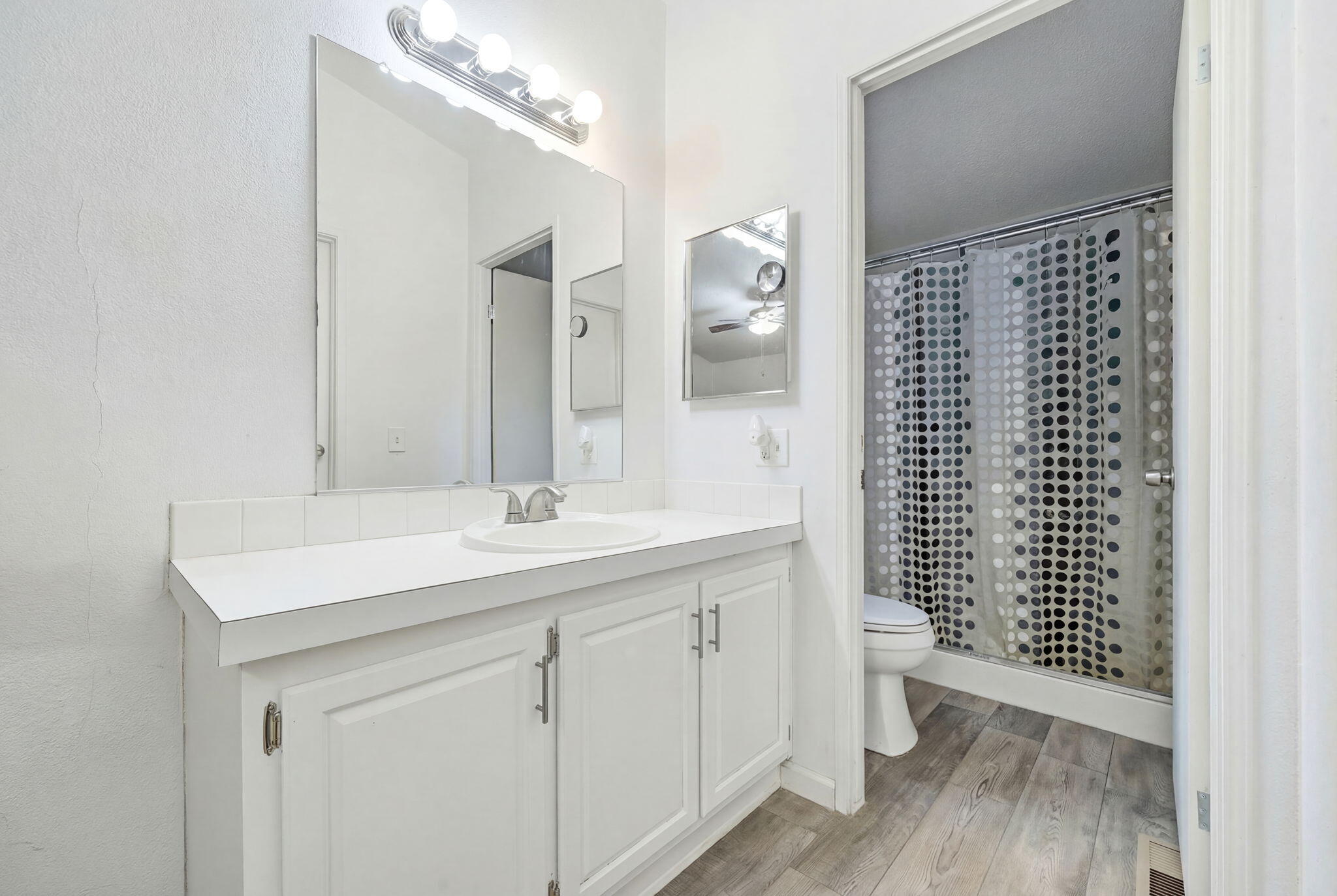 11705 Parey Avenue, Unit 7 Red Bluff, CA 96080 - Photo 20 of 34 a bathroom with a sink a toilet a mirror and shower