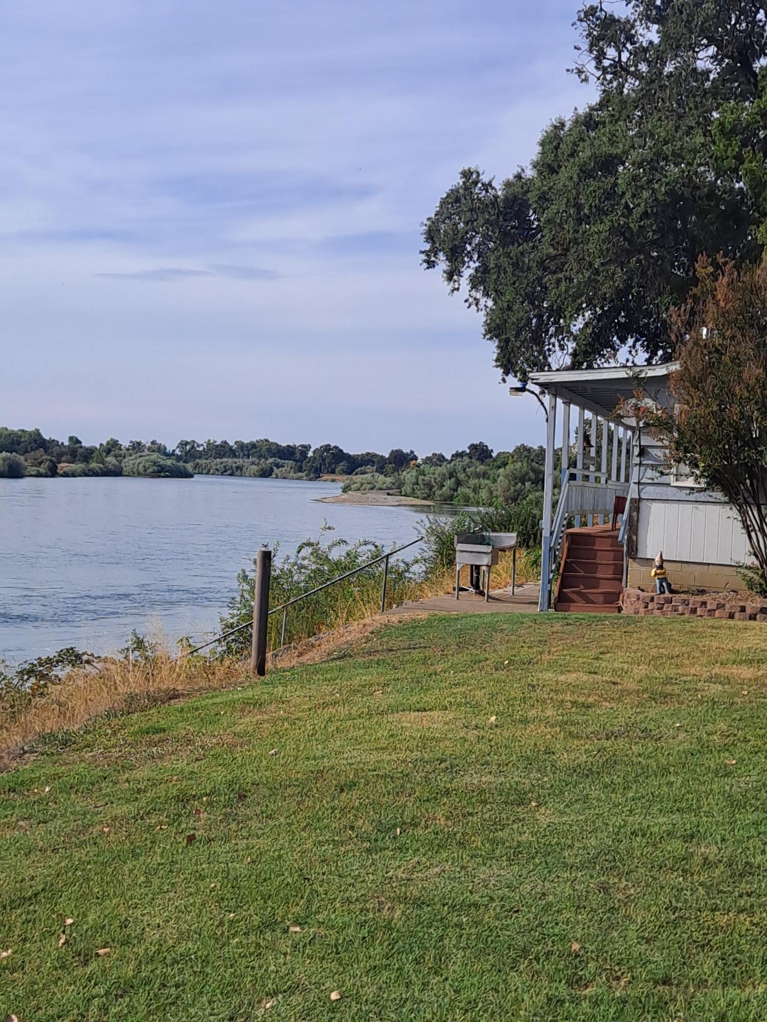 11705 Parey Avenue, Unit 7 Red Bluff, CA 96080 - Photo 29 of 34 a view of a lake with a big yard and large trees